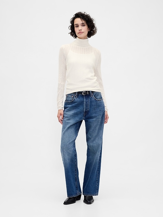 pull à col roulé en maille ajourée